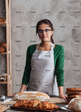 demo-attachment-650-op_happy-young-lady-baker-standing-at-bakery-near-PK9JSB5